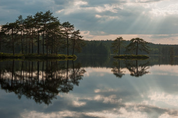 Sunrise over the lake with the reflection in the water, long shutter speed