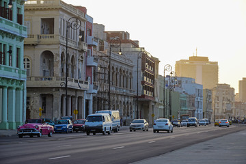 Fototapeta na wymiar Malecon promenade with retro cars at sunset in Havana, Cuba