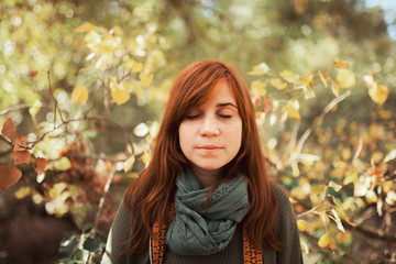 Young woman portrait with closed eyes in the forest