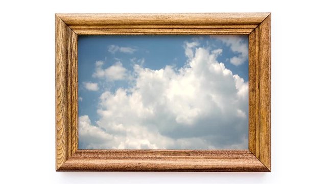 Creative 4k time laps video of moving clouds in a beautiful wooden picture frame. 3D effect of a moving image in a static frame.