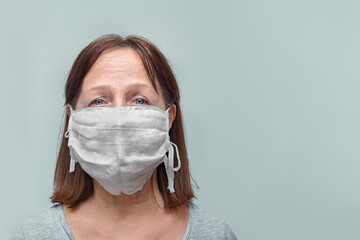Old woman wearing a mask fear problem air pollution on a white background, healthcare concept.