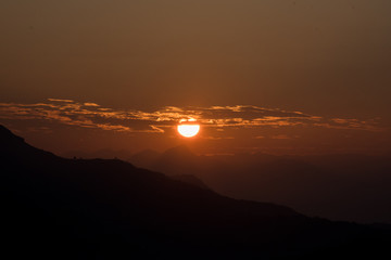 Beautiful Sunrise and Beautiful sunset between the mountain with orange sky, Blue sky 