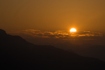 Beautiful Sunrise and Beautiful sunset between the mountain with orange sky, Blue sky 