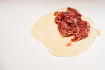 minced meat on raw dough