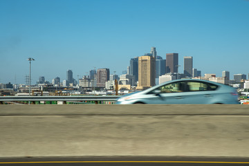 Naklejka premium Car drive through a bridge with a view of downtown Los Angeles