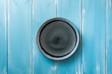 Plate on blue wooden background