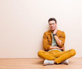 young arabian man holding cheek and suffering painful toothache, feeling ill, miserable and...
