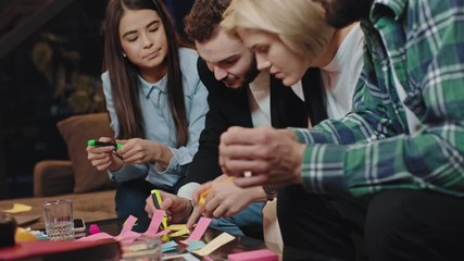 Good looking and charismatic group of mature students in the library while doing they re statistic project work make some notes and concentrated they analyzing and chatting with each other. 4k - Powered by Adobe