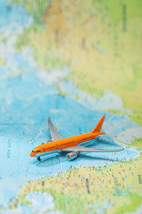selective focus of small plane on world map