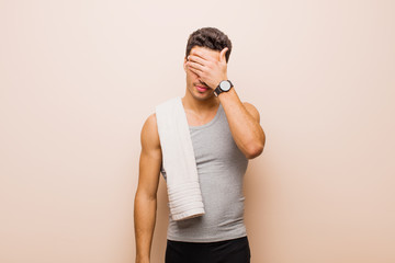 young arabian man covering eyes with one hand feeling scared or anxious, wondering or blindly...