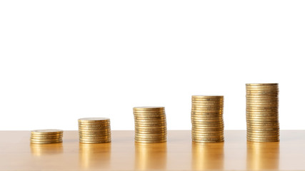 golden coins stacks on a wooden desk