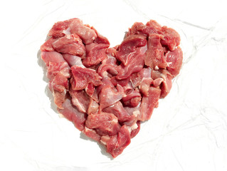 heart shaped chicken pieces of fresh meat on white background