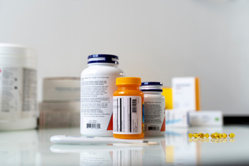 Pills in blisters are on the table. Medications on a white table.