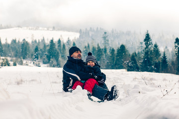 Fototapeta na wymiar Happy family enjoying wonderful winter landscapes together