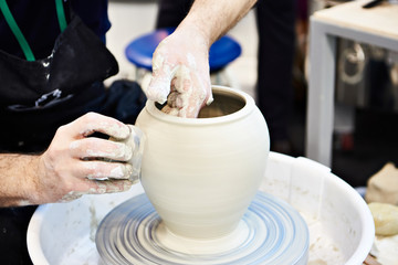 Fototapeta na wymiar Hands of master in pottery workshop