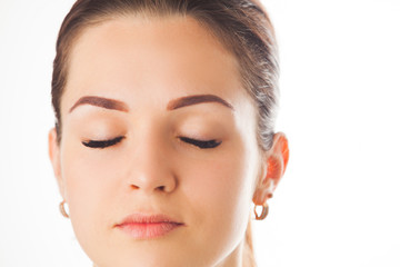 Female face with long eyelashes, beautiful makeup and brown eyebrow close-up.