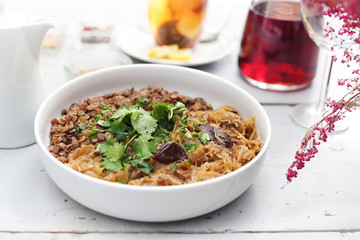 Cabbage with mushrooms and green lentils. Appetizing dish. Ready meal on a plate. Suggestion of serving food.