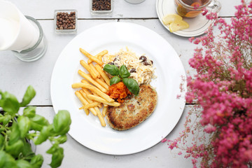 Vegetable cutlet with fries and salad. Appetizing dish. Ready meal on a plate. Suggestion of serving food.
