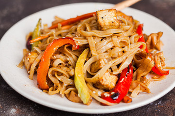 Asian vegan udon noodles with tofu and vegetables