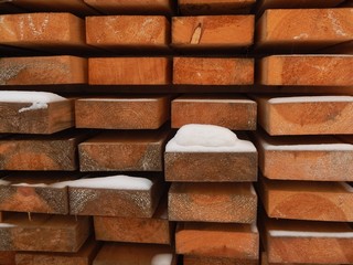 voluminous background of the end parts of long wooden blocks with a snow coating