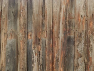 brown wooden surface from old untreated boards stacked on top of each other