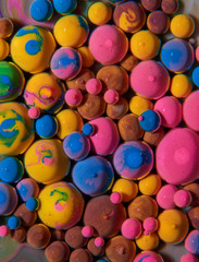 Macro photography of colorful bubbles on some fluids that seems to be some kind of unknown worlds.