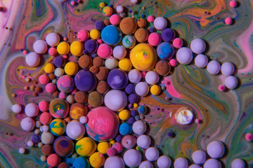 Macro photography of colorful bubbles on some fluids that seems to be some kind of unknown worlds.
