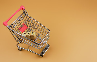 tax word in cart on orange background