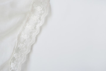Fototapeta premium White soft wrinkle thin fabric blanket texture background, wallpaper, backdrop. Space for text.