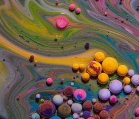 Macro photography of colorful bubbles on some fluids that seems to be some kind of unknown worlds.