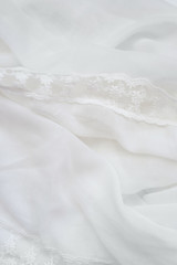 White soft wrinkle thin fabric blanket texture background, wallpaper, backdrop. Space for text.