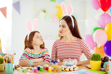 Close-up portrait of two nice attractive comic humorous playful cheerful girls small little pre-teen daughter wearing bunny ears holding pencil pout lips grimacing in white light interior room house