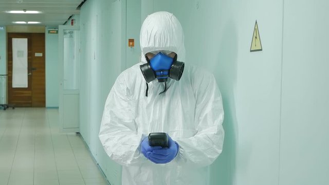 a virologist measures the level of radiation and determines the amount of harmful substances in the room