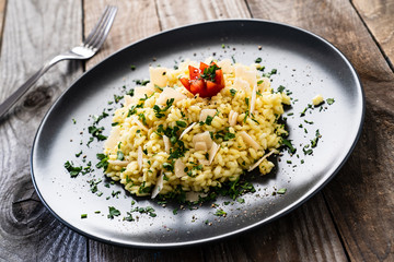 Risotto with parmesan on wooden background