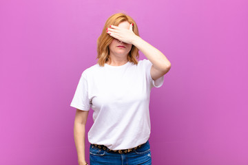 middle age woman covering eyes with one hand feeling scared or anxious, wondering or blindly...