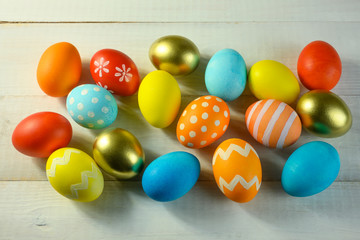 Easter colored eggs lie on a wooden table