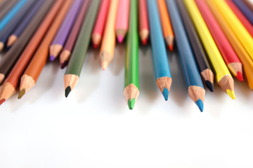 Colored pencils lie in a row