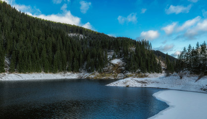 Fototapeta na wymiar mountain lake winter time on a sunny day 