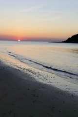 Sunset at Nacpan beach, with small island, El Nido, Palawan, Philippines