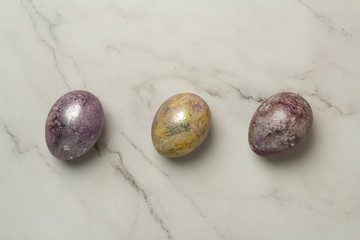 three multi-colored easter eggs