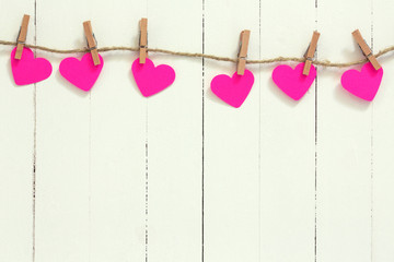 Pink hearts hanging on a string.Valentines day background