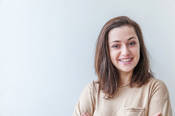 Obraz premium Happy girl smiling. Beauty portrait young happy positive laughing brunette woman on white background isolated. European woman. Positive human emotion facial expression body language