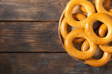 Bagels on a wooden plate on a brown wooden table. Rustic style. Homemade cake