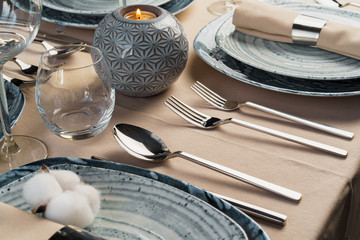 Table setting with stylish dishware on beige tablecloth