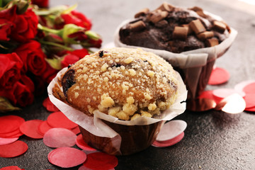 chocolate muffins, blueberry muffin and nut muffins on dark background for Valentine's day....