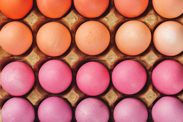 Traditional Christian eastertime, painted eggs in egg box.