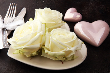 White rose on white dish. Meal on Valentines Day for the woman you love