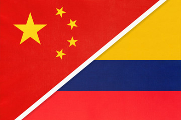 China or PRC vs Colombia national flag from textile. Relationship between asian and american countries.