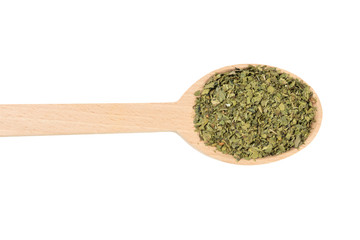 dried lovage herb in wooden spoon isolated on white background. spices and food ingredients. spices and food ingredients
