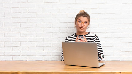 young pretty latin woman scheming and conspiring, thinking devious tricks and cheats, cunning and...